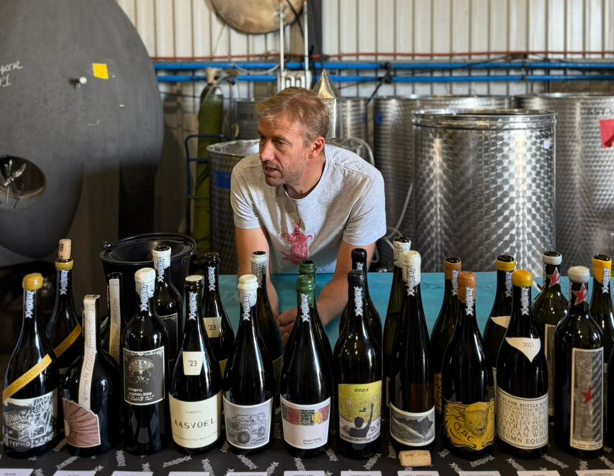 Pieter Walser in the winery, with a lineup of his wines